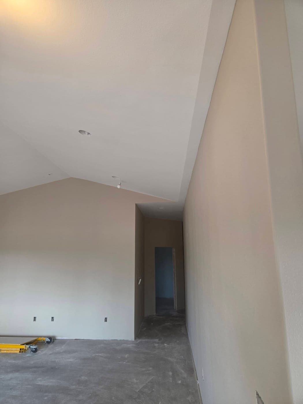 Tall painted walls and a vaulted ceiling in a new-construction home